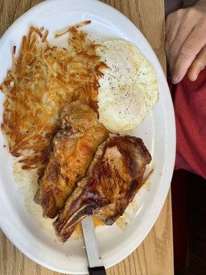 Grilled pork chops with hash browns and over easy egg