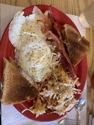 Two eggs over hard, bacon, hash browns, wheat toast