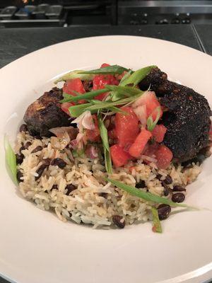 Jamaican jerk chicken topped with watermelon salsa over black beans and rice