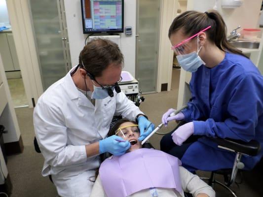 Dr. Hummer and Vanessa D.A. giving the patient an oral exam.