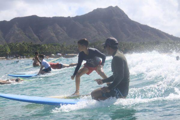 Isaiah is riding along his students side and giving him coaching as they ride.