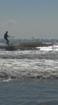 Mike surfing the waves on one of our paddle boards. :)