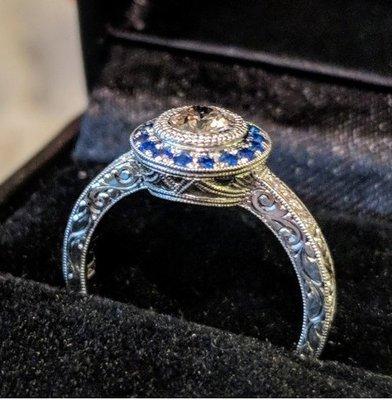 custom designed engagement ring. platinum with sapphire halo and pave diamonds, using an heirloom ~1/3ct diamond in a bezel setting.