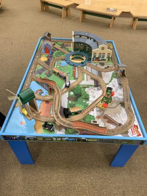 They have a cool train table for kids to hang out and play