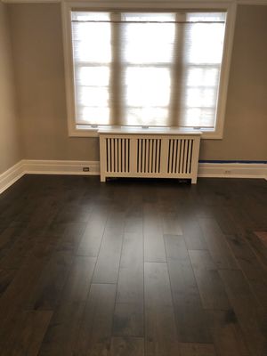 Existing hardwood and subflooring removed, new plywood with leveling installed. And Prefinished engineered wood floor installed on top.