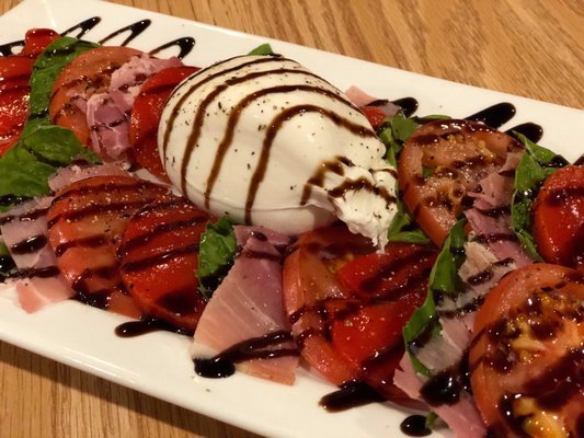 The most amazing plate of Buratta, tomatoes, fresh basil, prosciutto and roasted red peppers!