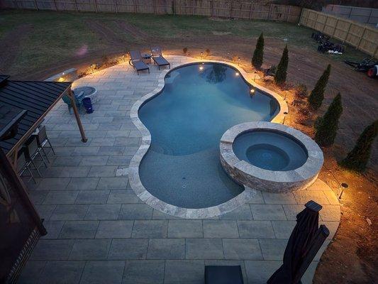 Concrete Pool, Silver travertine copping and paver decking. Raised spa