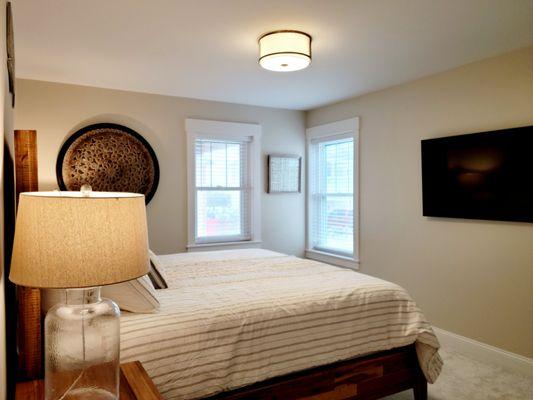 Downstairs king sized bedroom with bath and 55" Samsung QLED TV.