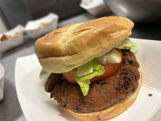 Our mouth watering Crabby Patty with our house sauce with lettuce tomatoes and onions on a bun