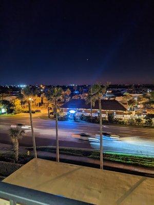 Street view at night. pictured-Whiskey Beach Pub across the street for a Burger,  a cheap cocktail and some live music after a beach day.