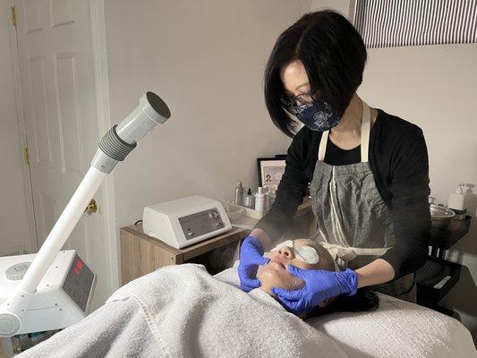 Opening up the pores and exfoliating as part of the Deep Pore-Cleansing Acne Facial.