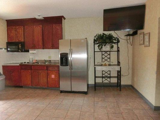 Full sized granite countertop kitchen with stove, microwave, sink, refrigerator, and coffee maker. We also include pots and pans + utensils!