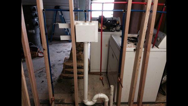 Plumbing being installed for basement apartment.