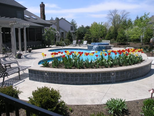 Back yard resort including pool, spa, waterfall, pergola, garden gateway and colorful seasonal plantings.