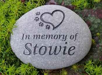 Medium sized river stone pet memorial engraved with the "heart with paws" graphic