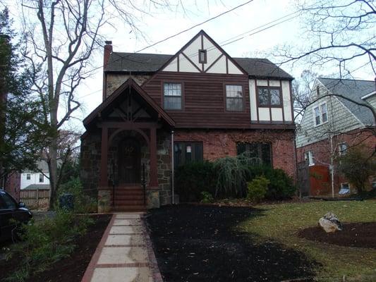 Replaced brick steps with a covered portico. The portico's stone base and brick steps match the existing columns while the ro...