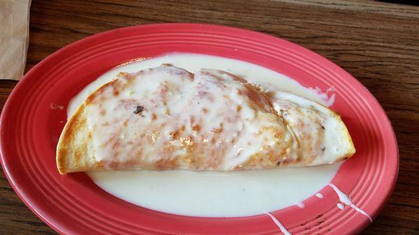 chicken quesadilla with queso sauce on top