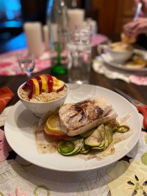 Paper wrapped Halibut with zucchini in a tiquila apple lime cilantro sauce. Served with apples and orange jasmine rice.