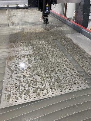 Cutting steel with Omax Waterjet. Call us for a quote.