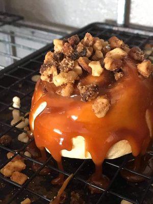 Cinnamon roll with caramel sauce and roasted walnuts