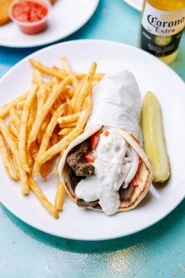 Gyro with our house made Tzatziki sauce, onions and tomatoes.