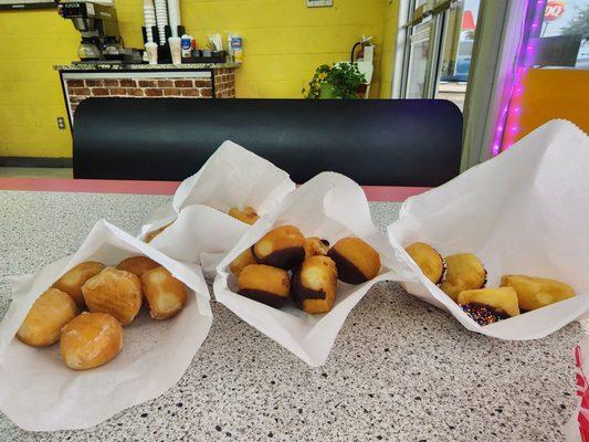 Enjoying different donut holes at one of the 2 booths