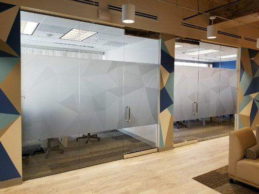 Amazing printed frosted privacy panels that match the custom painting of the geometric shapes around the conference room