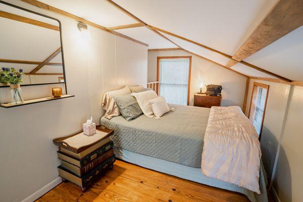 Enjoy the little touches in the loft bedroom of the Treehouse and sleep in comfort in a queen-sized bed.