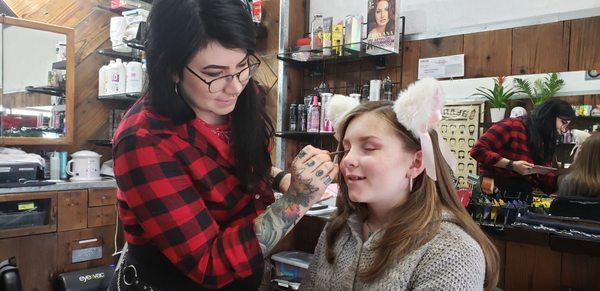 Here she is putting the finishing touches on my girl's eyes and giving little tips on everyday hair care.