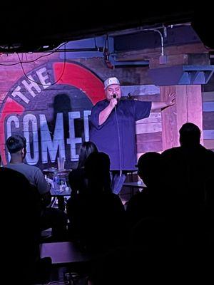 Ken Flores on stage at the Comedy Bar