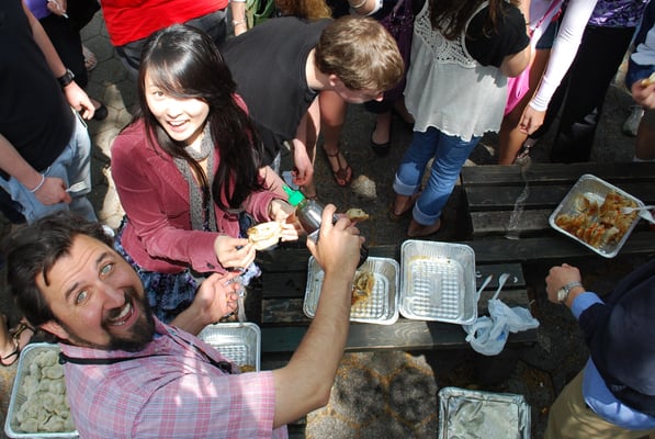 Jonathan passing out Chinese dumplings to famished Florida teens while on our Ethnic Eats tour