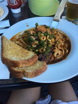 Steak Louisiana: blackened top sirloin on Cajun noodles with bay shrimp