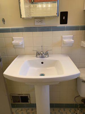 Removed old leaking wall hung lavatory and installed new pedestal, bowl, and faucet.