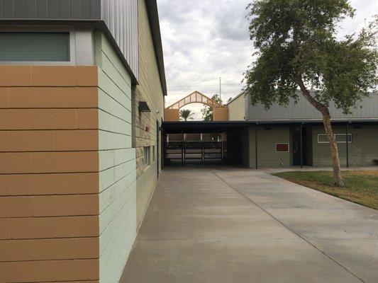 In a courtyard area facing the back side of the main entrance.