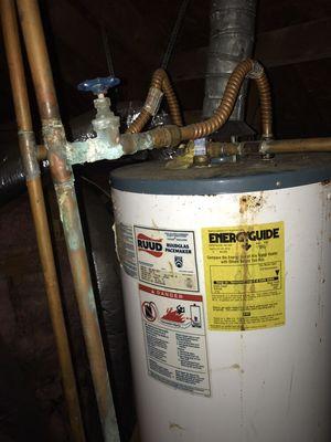 Picture shows a old water heater which flooded in a attic. Prior to replacing. If your heater looks like this call us before any damages.