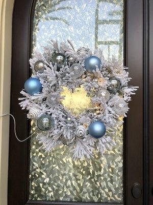 Custom made wreath with lights on the front door