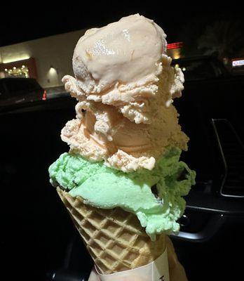 Medium cone has like four scoops already ate the little one. This one has peach on top and mint chocolate chip on bottom... Yummy.