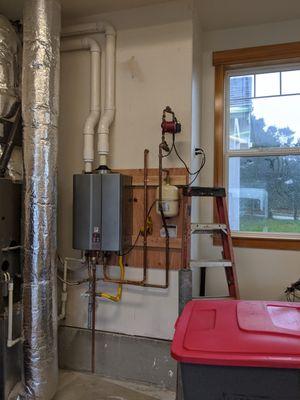 I pulled a 75 gallon water heater and retrofit the hot water system with this high efficiency Rinnai tankless water heater.