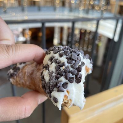 Bite of chocolate chip cannoli in Quincy Market