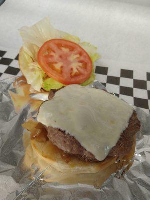 Beef patty with Lettuce tomato mayo mustard katchup grilled onions and cheese.