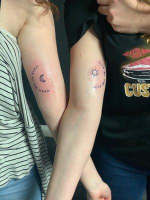 Matching tattoos. " live by the sun, love by the moon"