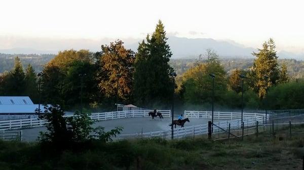 View from the bridle path of the outdoor arena at Grateful Pine Farm.