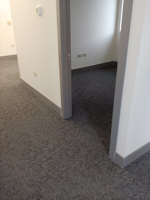 Installed carprt tile in a commercial space, followed by base and door casing