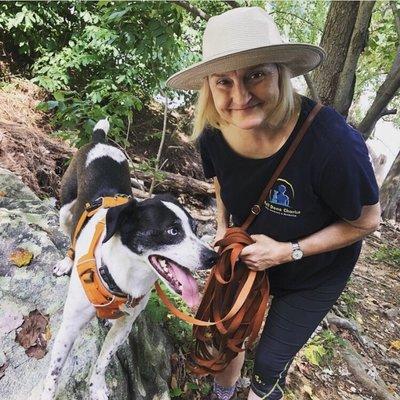 Trainer Toni hiking with her dog Menchie at Turkey Run.