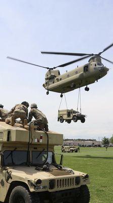 Utility Humvee being transported by a Chinook during training exercise