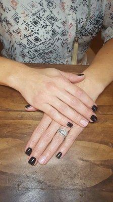 Black gel nails with pink accent nail.