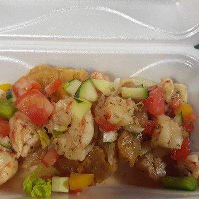 Sauteed shrimp with onion garlic and bell peppers,  over fried breadfruit or green plantains.