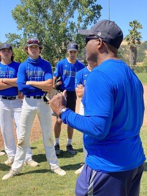 EJ sharing information in baseball with the Warriors team.