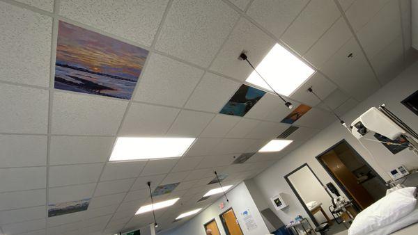 Painted ceiling tiles above therapy tables