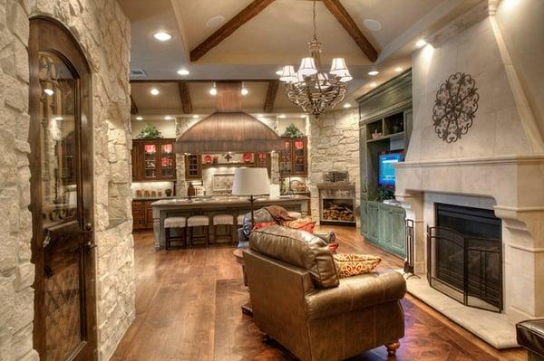 This kitchen is beautiful mix of stone, bronze, and stained wood.  This Houston kitchen takes you on a trip to the European countryside.